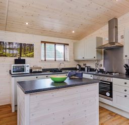 A kitchen with cabinets and a countertop at Hurricane Lodge in Fair Oak