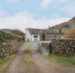 A house with a stone wall and pathway at Thrang View in Chapel Stile