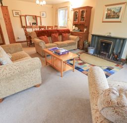 A living room with a sofa arrangement and dining area at Thrang View in Chapel Stile