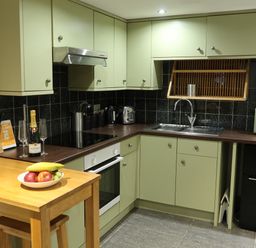 A kitchen with a countertop, sink, and stove at Rockfish Cottage in Brixham