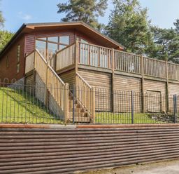A house with a deck and stairs at High Lake View Lodge White Cross Bay near Troutbeck Bridge