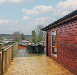 An outdoor deck with a table and chairs at High Lake View Lodge White Cross Bay near Troutbeck Bridge