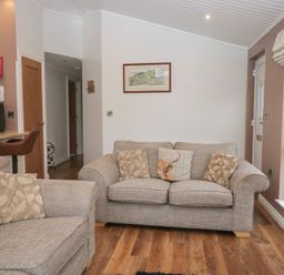 A living room with sofas and a television at High Lake View Lodge White Cross Bay near Troutbeck Bridge