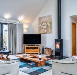 A living room with a television and coffee table at Beachcombers in Marhamchurch