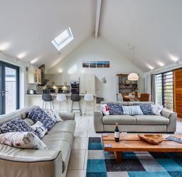 A living room with a sofa and coffee table at Beachcombers in Marhamchurch