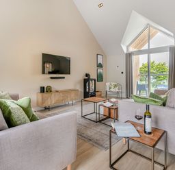 A living room with a sofa and coffee table at Gwari Spa Barn 2.0 Marhamchurch