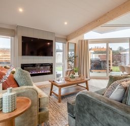 A living room with a sofa and a coffee table at Trelowen 2.0 Spa Marhamchurch