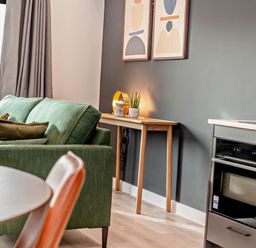 A living room with a sofa and table at Arvor Duplex 2.0 in Marhamchurch