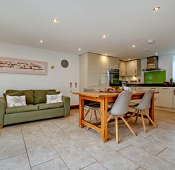 A kitchen with a table and chairs at Jack's House in Marhamchurch