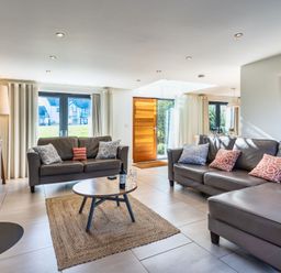 A living room with a sofa and coffee table at Arundell in Marhamchurch