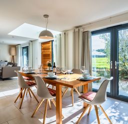 A dining room with a table and chairs at Arundell in Marhamchurch