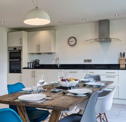 A kitchen with a dining table set at Eagle's Nest in Marhamchurch