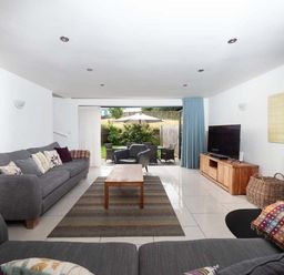 A living room with a sofa and coffee table at Medlands in Marhamchurch