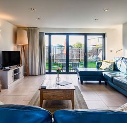 A living room with a sofa and coffee table at Trevelyan in Marhamchurch