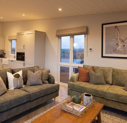 A living room with sofas and a coffee table at Trelowen 3.0 Spa in Marhamchurch