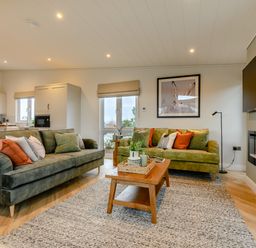 A living room with sofas and a coffee table at Trelowen 3.0 Spa in Marhamchurch