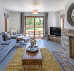 A living room with a sofa and coffee table at Windy Hills Spa in Marhamchurch