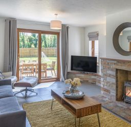 A living room with a sofa and coffee table at Windy Hills Spa, Marhamchurch