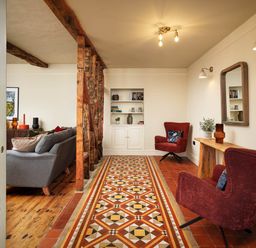 A living room with a sofa and chairs at Whalesborough Farmhouse Spa in Marhamchurch