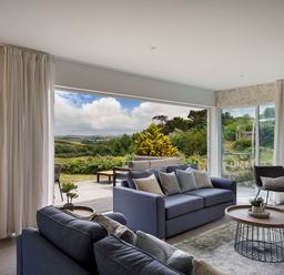 A living room with a sofa and coffee table at Whalesborough Cottage Spa, Marhamchurch