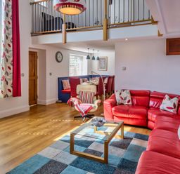 A living room with a sofa and coffee table at Calf House Spa Marhamchurch
