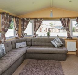 A living room with a sofa and television at Caravan 2 at Blackmoor Farm near tenby