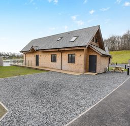 A house with a gravel area and bench at Tranquillity 4 (Pet) in Carnforth