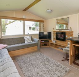 A living room with a sofa and television at Caravan 3 at Blackmoor Farm near tenby