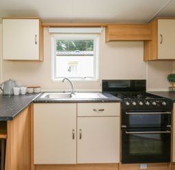 A kitchen with a sink and oven at Caravan 3 at Blackmoor Farm near tenby