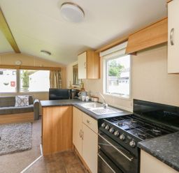 A kitchen with a gas stove and sink at Caravan 3 at Blackmoor Farm near tenby Narberth