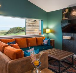 A living room with a sofa and television at The Telfer in North Berwick