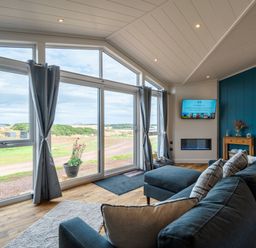 A living room with a sofa and a television at The Townsend in North Berwick
