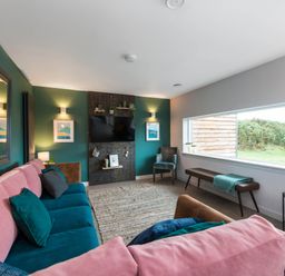 A living room with a sofa and television at The Laidlaw Spa in North Berwick