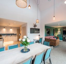 A kitchen and living area with a table and chairs at The Laidlaw Spa North Berwick