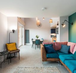 A living room with a sofa and dining table at The Laidlaw Spa in North Berwick