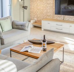 A living room with a sofa and coffee table at Godolphin Stable in Bude