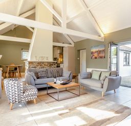A living room with a sofa and coffee table at Godolphin Stable in Bude