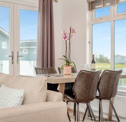 A dining room with a table and chairs at Kynance (Pet) Bude