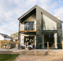 A house with a balcony and decking at The Glasshouse in Bude
