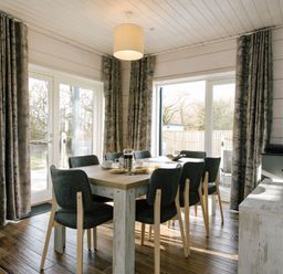 A dining room with a table and chairs at The Glasshouse in Bude