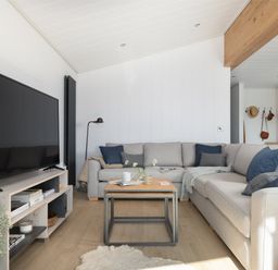 A living room with a sofa and coffee table at Sennen 3 Spa (Pet) Bude