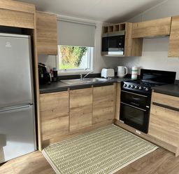 A kitchen with appliances and cabinetry at Willerby Ellerrton (delyn) Prestatyn