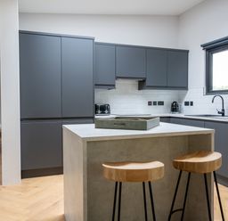 A kitchen with gray cabinets and a countertop at Cabin 2.0 in Dumfries