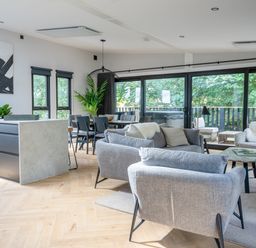 A living room with a sofa and dining area at Cabin 2.0 Deluxe Dumfries