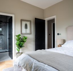 A bedroom with a bed and plant at Cabin 2.0 Deluxe in Dumfries