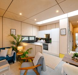 A living room with a sofa and a kitchen at Orka 2.0 Kinder (Pet) Dumfries