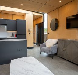 A living room with a kitchen and a sofa at Orka Duo 2.0 (Pet) Dumfries