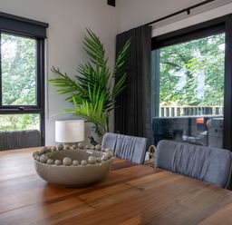 A dining room with a wooden table and chairs at Cabin 3.0 Deluxe in Dumfries