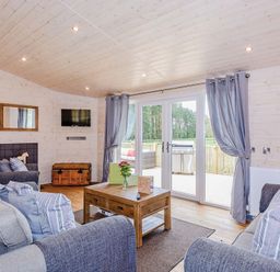 A living room with sofas and a coffee table at Lancaster Lodge in Fair Oak