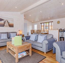 A living room with sofas and a coffee table at Lancaster Lodge in Fair Oak